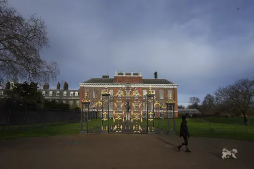 A dog walker passes Kensington Palace in London, Friday, Jan. 6, 2023. The first official photo of Kate, the Princess of Wales, since she underwent abdominal surgery nearly two months earlier, was pulled from circulation by The Associated Press and several other news organizations, Sunday, March 10, 2024, because the image appeared to have been manipulated. (AP Photo/Kirsty Wigglesworth, File)