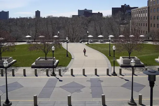 A person walks on campus at University of Minnesota in Minneapolis on April 21, 2020. (Glenn Stubbe/Star Tribune via AP, File)