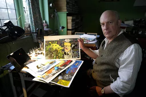 Martin Rowson shows Britain's Prime Minister Boris Johnson cartoons as he poses for a photographer in his studio in London, Monday, Jan. 24, 2022. So the bad news besetting British Prime Minister Boris Johnson over allegations of lockdown-breaching government parties has been good news for Britain's humorists, producing an outpouring of satirical responses. Political cartoonist Martin Rowson says mockery is one of the trade-offs in democratic societies between government and governed: “They ha