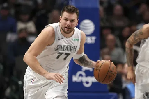 Dallas Mavericks guard Luka Doncic brings the ball up the court during the first half of an NBA basketball game against the San Antonio Spurs Saturday, Nov. 16, 2024, in Dallas. (AP Photo/Jeffrey McWhorter)