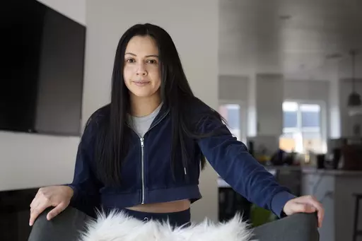 Cassandra Nuñez poses for a portrait at home Thursday, May 11, 2023, in Inglewood, Calif. Nuñez and her grandmother cast their first ballots in a U.S. presidential election in 2016. She was a first-year college student; her grandmother, a newly minted citizen. (AP Photo/Marcio Jose Sanchez)