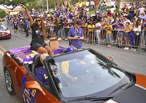 LSU forward Angel Reese waves to fans as the women's NCAA college national champion basketball team paraded across campus in Baton Rouge, La., Wednesday, April 5, 2023. Angel Reese is still getting used to the idea that celebrity athletes and entertainers she's long wanted to meet are interested in meeting her, too -- and thanking her for how she's elevated women's basketball.(Hilary Scheinuk/The New Orleans Advocate via AP, File, File)