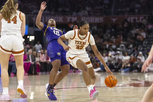 Texas forward Madison Booker (35) drives around LSU guard Mikaylah Williams (12) during the second half of an NCAA college basketball game in Austin, Texas, Sunday, Feb. 16, 2025. (AP Photo/Stephen Spillman)