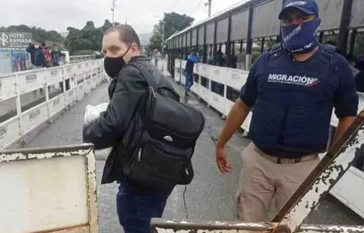 In this photo provided by the Kenemore family, Jerrel Kenemore stands at a Colombian checkpoint in the middle of the Simon Bolivar international bridge connecting San Antonio del Tachira, Venezuela with Villa del Rosario, Colombia, the second week of March 2022. Kenemore, from the Dallas area, is one of at least three American citizens who were quietly arrested in 2022 allegedly trying to enter Venezuela illegally and are being held at a maximum security prison facing long sentences, The Associa