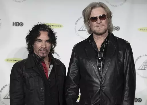 Hall of Fame Inductees John Oates, left, and Daryl Hall appear in the press room at the Rock and Roll Hall of Fame Induction Ceremony on April, 10, 2014, in New York. After more than a half-century of making music together, Hall is suing Oates over a proposed sale of his share of a Hall & Oates business partnership that Hall says he hasn't approved. A Nashville judge recently paused the sale of Oates' stake in Whole Oats Enterprises LLP to Primary Wave IP Investment Management LLC pending arbitr
