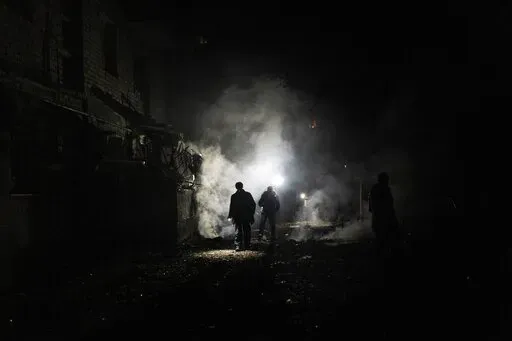 Resident walks amid debris after a Russian attack in Kherson, southern Ukraine, Nov. 24, 2022. In a deliberate, widespread campaign, Russian forces systematically targeted influential Ukrainians, nationally and locally, to neutralize resistance through detention, torture and executions, an Associated Press investigation has found. (AP Photo/Bernat Armangue, File)