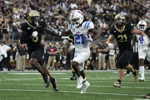 Mississippi running back Henry Parrish Jr. (21) runs for a touchdown against Wake Forest defensive back Rushaun Tongue (6) during the first half of an NCAA college football game in Winston-Salem, N.C., Saturday, Sept. 14, 2024. (AP Photo/Chuck Burton)