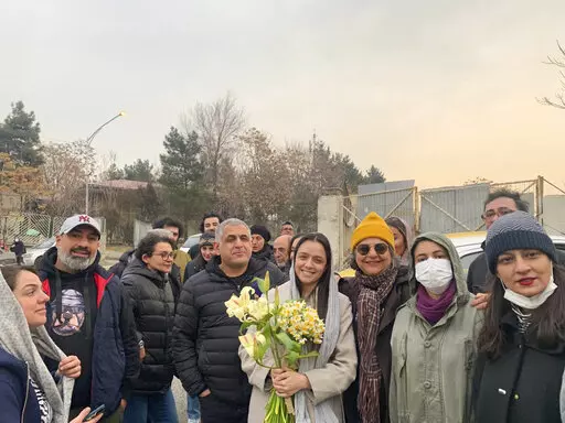 Iranian prominent actress Taraneh Alidoosti, center, holds bunches of flowers as she poses for a photo among her friends after being released from Evin prison in Tehran, Iran, Wednesday, Jan. 4, 2023. Iran released Alidoosti, a prominent actress from an Oscar-winning film, nearly three weeks after she was jailed for criticizing a crackdown on anti-government protests. (Gisoo Faghfouri, Sharghdaily, via AP)
