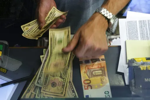 A cashier changes a 50 Euro banknote with US dollars at an exchange counter in Rome, Wednesday, July 13, 2022. Inflation for the European countries using the euro currency hit another record in August, fuelled by soaring energy prices mainly driven by Russia’s war in Ukraine. Annual inflation in the eurozone’s 19 countries rose to 9.1% in August, up from 8.9% recorded in July. That's according to the latest figures released Wednesday, Aug. 31, 2022 by the European Union statistics agency. (A