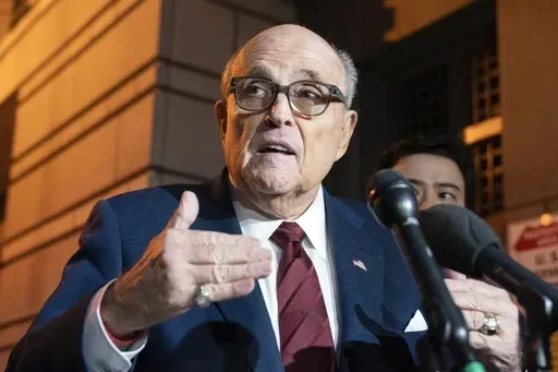 Former New York Mayor Rudy Giuliani talks to reporters as he leaves the federal courthouse in Washington, Dec. 11, 2023. A judge threw out Rudy Giuliani’s bankruptcy case on Friday, July 12, 2024, finding that the former New York City mayor had flouted the process with a lack of transparency. (AP Photo/Jose Luis Magana, File)