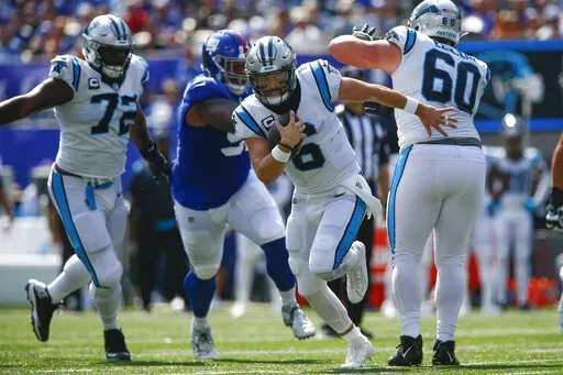 Carolina Panthers quarterback Baker Mayfield (6), center, runs with the ball during the first half an NFL football game against the New York Giants, Sunday, Sept. 18, 2022, in East Rutherford, N.J. (AP Photo/John Munson)