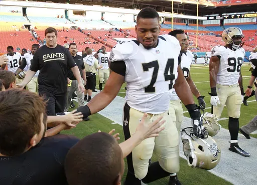 New Orleans Saints defensive end Glenn Foster Jr. (74) greets fans after practice before an NFL preseason football game against the Miami Dolphins, Thursday, Aug. 29, 2013, in Miami Gardens, Fla. (AP Photo/Wilfredo Lee, File)