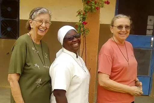 This undated photo courtesy of Marianites of Holy Cross, shows from left, Sister Suellen Tennyson, with Sister Pascaline Tougma, a midwife from Burkina Faso,  and Sister Pauline Drouin, a nurse from Lake Magantic in Canada.   Sister Suellen Tennyson was taken from her bed in Yalgo, Burkina Faso,  late Monday, April 4, 2022 , Sister Ann Lacour, U.S. congregational leader for the Marianites of Holy Cross in Covington, Louisiana, told The Associated Press.  (Courtesy of Marianites of Holy Cross via