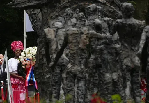 Wreath laying at the National Slavery Monument after Amsterdam Mayor Femke Halsema apologized for the involvement of the city's rulers in the slave trade during a nationally televised annual ceremony in Amsterdam, Netherlands, Thursday, July 1, 2021. The Netherlands is expected to issue a national apology for its brutal slavery past when Dutch officials visit their former Caribbean colonies in late Dec. 2022. (AP Photo/Peter Dejong, File)