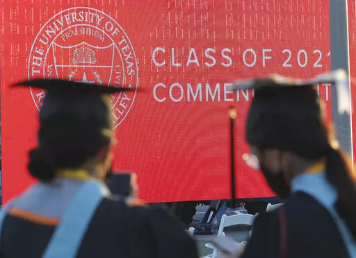 Graduates of the University of Texas Rio Grande Valley attend their commencement ceremony at the schools parking lot on Friday, May 7, 2021, in Edinburg, Texas. Graduate degrees, once touted as the new bachelor’s degrees, are becoming less crucial to get jobs. Today, more college graduates than ever hold advanced degrees, and graduate programs are the only area of higher education that saw enrollment increases during the worst of the pandemic.  (Delcia Lopez/The Monitor via AP)