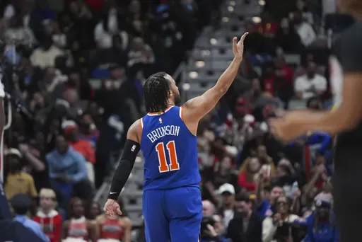 New York Knicks guard Jalen Brunson (11) reacts after making a 3-point basket in the second half of an NBA basketball game against the New Orleans Pelicans in New Orleans, Saturday, Dec. 21, 2024. The Knicks won 104-93. (AP Photo/Gerald Herbert)