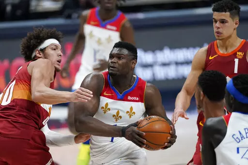 New Orleans Pelicans forward Zion Williamson (1) goes to the basket as  Denver Nuggets forward Aaron Gordon (50) defends in the second half of an NBA basketball game Wednesday, April 28, 2021, in Denver. The New Orleans Pelicans say Zion Williamson’s recovery from a right foot injury has improved to the point where he can gradually resume “full weight-bearing exercise” and “basketball activities, Wednesday, March 2, 2022.  (AP Photo/David Zalubowski, File)