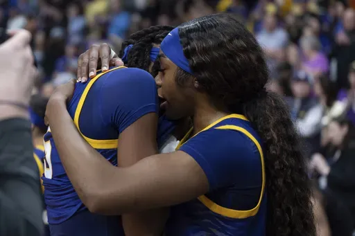 LSU forward Aneesah Morrow, right, hugs LSU forward Sa'Myah Smith after a game against UCLA in the Elite Eight of the NCAA college basketball tournament, Sunday, March 30, 2025, in Spokane, Wash. (AP Photo/Jenny Kane)