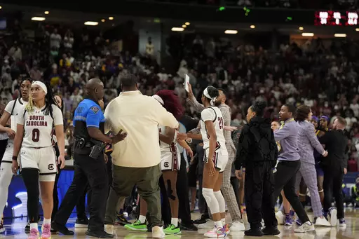 The benches clear during a player altercation during the second half of an NCAA college basketball game against LSU at the Southeastern Conference women's tournament final Sunday, March 10, 2024, in Greenville, S.C. (AP Photo/Chris Carlson)