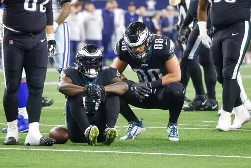 Philadelphia Eagles' A.J. Brown sits after being hurt during the second half of an NFL football game against the Dallas Cowboys Saturday, Dec. 24, 2022, in Arlington, Texas. (AP Photo/Michael Ainsworth)
