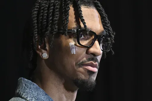 Washington Commanders quarterback Jayden Daniels speaks at a news conference after an NFL wild-card playoff football game against the Tampa Bay Buccaneers in Tampa, Fla., Sunday, Jan. 12, 2025. (AP Photo/Jason Behnken)