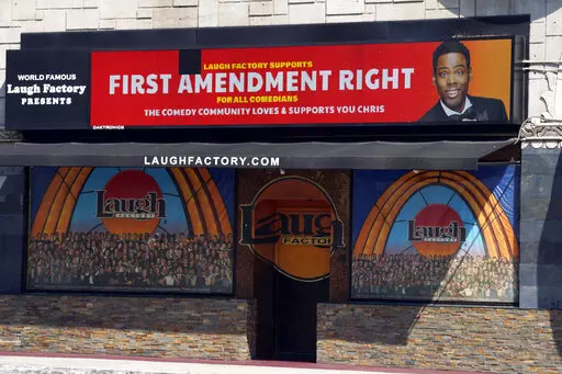 A message expressing support for comedian Chris Rock is displayed on the digital marquee of the Laugh Factory comedy club, Wednesday, March 30, 2022, in Los Angeles. Rock was slapped onstage by best actor winner Will Smith after making a joke about Smith's wife Jada Pinkett Smith during Sunday night's Academy Awards telecast. (AP Photo/Chris Pizzello)