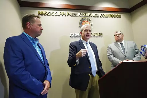 Northern District Public Service Commissioner Brandon Presley, center, speaks about the Mississippi Public Service Commission securing a $300 million settlement with Entergy Mississippi, a integrated energy company, Thursday, June 23, 2022, in Jackson, Miss. (AP Photo/Rogelio V. Solis)