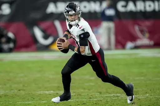 Atlanta Falcons quarterback Desmond Ridder (9) runs out of the pocket against the Arizona Cardinals during the second half of an NFL football game, Sunday, Nov. 12, 2023, in Glendale, Ariz. (AP Photo/Matt York)