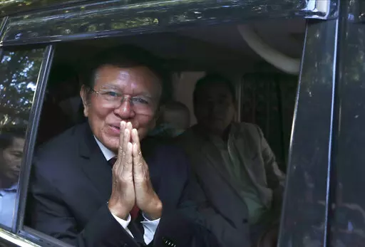 Former President of Cambodia National Rescue Party, Kem Sokha, greets from his car in front of his house in Phnom Penh, Cambodia, Friday, March 3, 2023. Cambodia’s beleaguered pro-democracy forces face another day of reckoning Friday, as the country’s most prominent opposition politician not in exile is scheduled to hear the verdict in his trial for treason.(AP Photo/Heng Sinith)