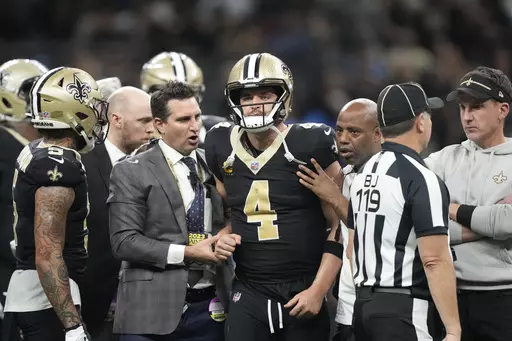 New Orleans Saints quarterback Derek Carr (4) is helped off the field during the second half of an NFL football game against the Detroit Lions, Sunday, Dec. 3, 2023, in New Orleans. (AP Photo/Gerald Herbert)
