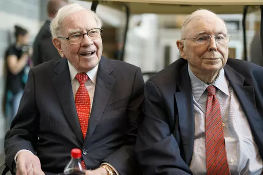 FILE- In this May 3, 2019 file photo, Berkshire Hathaway Chairman and CEO Warren Buffett, left, and Vice Chairman Charlie Munger, briefly chat with reporters before Berkshire Hathaway's annual shareholders meeting. Buffett credited his longtime partner — the late Charlie Munger — with being the architect of the Berkshire Hathaway conglomerate he’s received the credit for leading and warned shareholders in his annual letter not to listen to Wall Street pundits or financial advisors who urge