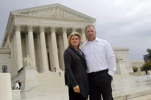 Michael and Chantell Sackett of Priest Lake, Idaho, pose for a photo in front of the Supreme Court in Washington on Oct. 14, 2011. The Supreme Court on Thursday, May 25, 2023, made it harder for the federal government to police water pollution in a decision that strips protections from wetlands that are isolated from larger bodies of water. The justices boosted property rights over concerns about clean water in a ruling in favor of an Idaho couple who sought to build a house near Priest Lake in 