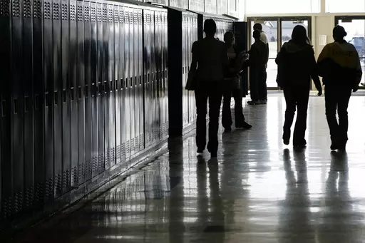 Students walk down a hallway at a high school in Iowa on Tuesday, Dec. 19, 2006. In 2024, bills in the Iowa, Kentucky, Missouri and West Virginia legislatures would require public school students to watch a fetal development video similar to one created by an anti-abortion group. The proposed legislation mirrors a law passed in North Dakota last year. (Scott Morgan/The Hawk Eye via AP)