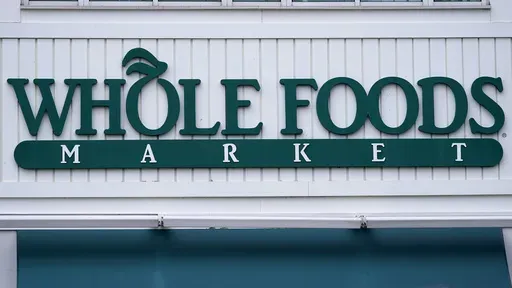 The Whole Foods Market logo is shown on the front of a store, July 14, 2021, in Cambridge, Mass. (AP Photo/Charles Krupa, File)
