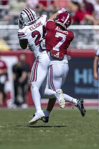South Carolina defensive back Jalon Kilgore (24) intercepts a pass in front of Alabama wide receiver Cole Adams (7) during the first half of an NCAA college football game, Saturday, Oct. 12, 2024, in Tuscaloosa, Ala. (AP Photo/Vasha Hunt)