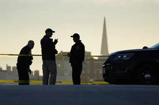 Police stand at the top of the closed street outside the home of House Speaker Nancy Pelosi and her husband Paul Pelosi in San Francisco, Friday, Oct. 28, 2022. Within hours of the attack on Paul Pelosi, conspiracy theories deflecting blame for the assault on the husband of U.S. Speaker Nancy Pelosi were already swirling online. (AP Photo/Eric Risberg, File)