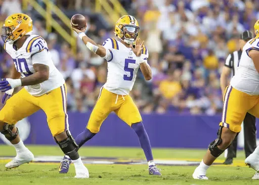 LSU quarterback Jayden Daniels (5) throws a pass during an NCAA college football game against Auburn in Baton Rouge, La., Saturday, Oct. 14, 2023. (Scott Clause/The Daily Advertiser via AP)