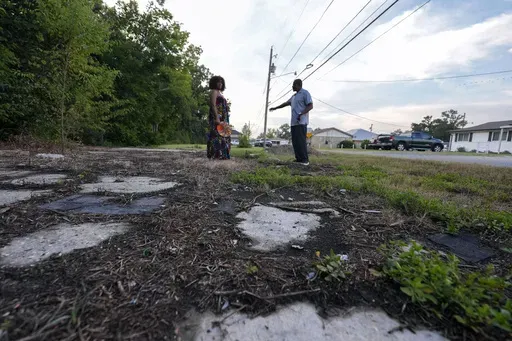 Arthur C. Blue, right, and Kimbrelle Eugene Kyereh talk about the changed landscape of the town they grew up in, alongside the IMTT facility in the Elkinsville section of St. Rose, La., Friday, Aug. 16, 2024. (AP Photo/Gerald Herbert)