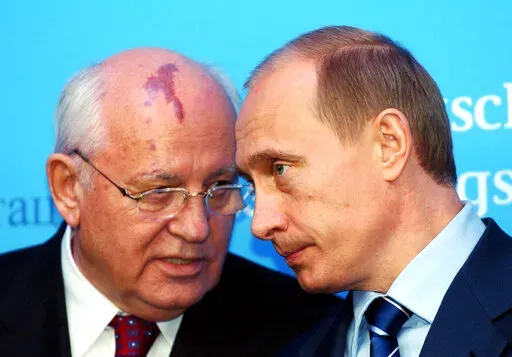 Russia's President Vladimir Putin, right, talks with former Soviet President Mikhail Gorbachev at the start of a news conference at the Castle of Gottorf in Schleswig, northern Germany, Tuesday, Dec. 21, 2004. Russian news agencies are reporting that former Soviet President Mikhail Gorbachev has died at 91. The Tass, RIA Novosti and Interfax news agencies cited the Central Clinical Hospital. (Carsten Rehder/dpa via AP)