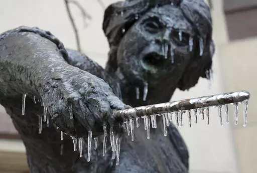 Icicles hang from the Angelina Eberly statue in downtown Austin, Texas, during a winter storm on Wednesday, Feb. 1, 2023. (Jay Janner/Austin American-Statesman via AP)