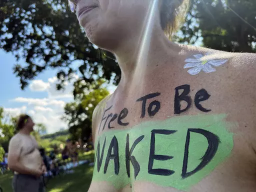 A rider poses at the start of the Philly Naked Bike Ride in Philadelphia, Saturday, Aug. 26, 2023. (AP Photo/Tassanee Vejpongsa)