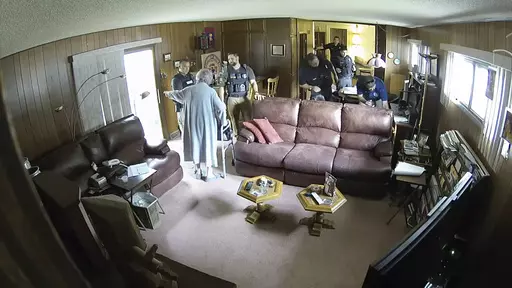 This screen grab of security camera footage provided by Eric Meyer shows his mother, Joan Meyer, ordering police officers to get out of her house as they searched it on Aug. 11, 2023, in Marion, Kan. Joan Meyer, who was 98, died the next day. Her son, Marion County Record Editor and Publisher Eric Meyer, blames his mother's death on the stress caused by the search. (Eric Meyer via AP)