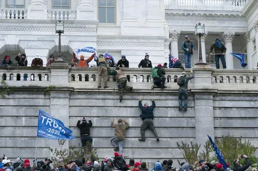 Supporters of President Donald Trump climb the west wall of the the U.S. Capitol in Washington, Jan. 6, 2021. (AP Photo/Jose Luis Magana, File)