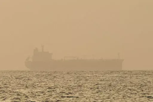 An oil tanker is moored off Fujairah, United Arab Emirates, Wednesday, Aug. 4, 2021. Technology to hide a ship's location previously available only to the world's militaries is spreading fast through the global maritime industry as governments from Iran to Venezuela — and the rogue shipping companies they depend on to move their petroleum products — look for stealthier ways to circumvent U.S. sanctions. (AP Photo/Jon Gambrell)