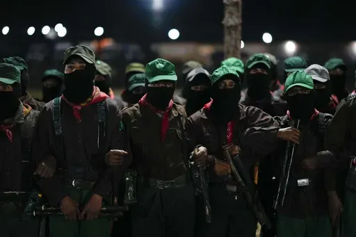 Members of the Zapatista National Liberation Army, EZLN, attend an event marking the 30th anniversary of the Zapatista uprising in Dolores Hidalgo, Chiapas, Mexico, Sunday, Dec. 31, 2023. (AP Photo/Eduardo Verdugo)