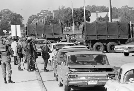 National Guardsmen and state troopers stop all traffic trying to enter the campus of Southern University at Baton Rouge, La., Nov. 17, 1972. Louisiana Gov. John Bel Edwards has issued an official apology for the deaths of two students who were shot by a law enforcement officer 50 years earlier during a protest at Southern University. (AP Photo/Jack Thornell, File)