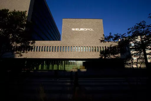 FILE- This Wednesday, Oct. 10, 2018, file photo shows the sun bouncing off the Europol headquarters in The Hague, Netherlands. Europol says law enforcement authorities in six different countries have joined forces to take down a “super cartel” of drugs traffickers controlling about one third of the cocaine trade in Europe. (AP Photo/Peter Dejong, File)