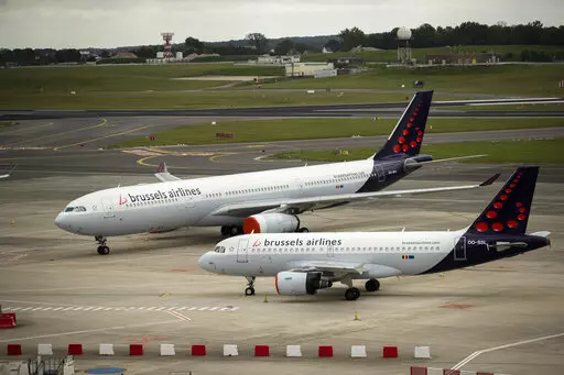 In this Tuesday, May 12, 2020 file photo, planes from Brussels Airlines on the tarmac at Brussels Airport in Brussels Tuesday, May 12, 2020. The European Union's airspace is filling up again with near-empty flights in pandemic times that even airlines admit serve no commercial purpose except securing valuable slots in some of the world's biggest airports. (AP Photo/Francisco Seco, File)