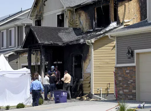 Investigators stand outside a house where five immigrants from Senegal were found dead after a fire in suburban Denver on Aug. 5, 2020. Kevin Bui pleaded guilty Friday, May 17, 2024, to a house fire that killed five members of the Senegalese family in 2020 in a case of misplaced revenge caused by mistakenly tracking his stolen iPhone to the home. (AP Photo/Thomas Peipert, File)