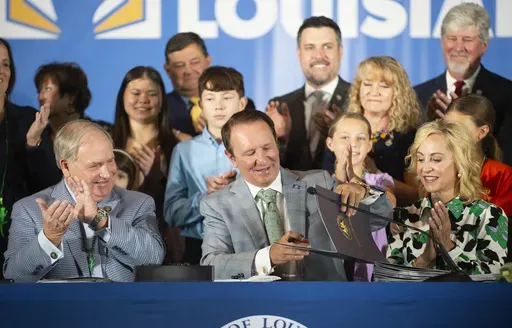 Louisiana Gov. Jeff Landry signs bills June 19, 2024, at Our Lady of Fatima Catholic School in Lafayette, La. A slew of legislation, including a first-of-its-kind law that allows judges to impose the punishment of surgical castration for offenders guilty of certain sex crimes against children, went into effect Thursday, Aug. 1. (Brad Bowie/The Times-Picayune/The New Orleans Advocate via AP, File)